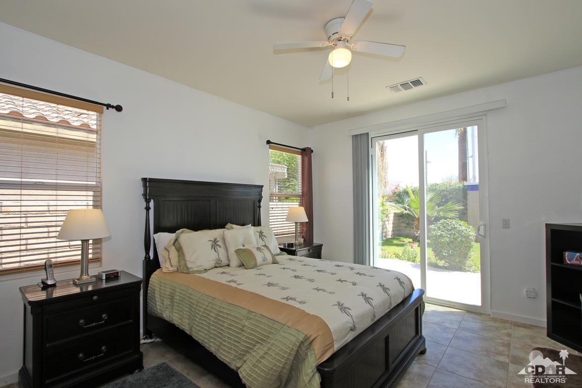 49898 Lewis Road Indio, CA 92201 - Photo 19 of 34 a bedroom with a bed and a flat tv screen on dresser