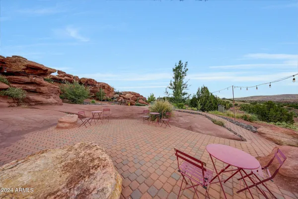 a view of a balcony with wooden floor and fence