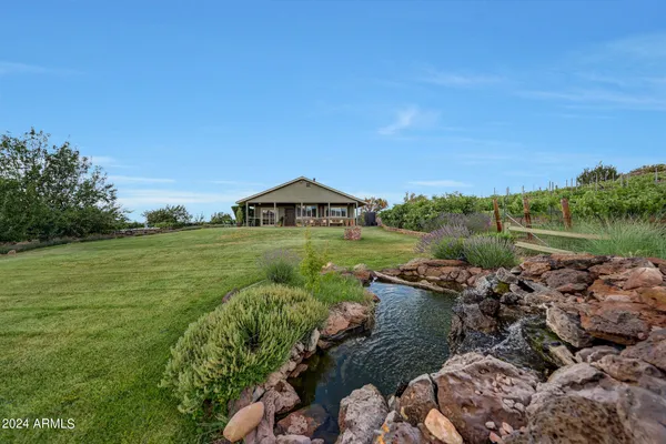 a view of a lake with couches in the patio