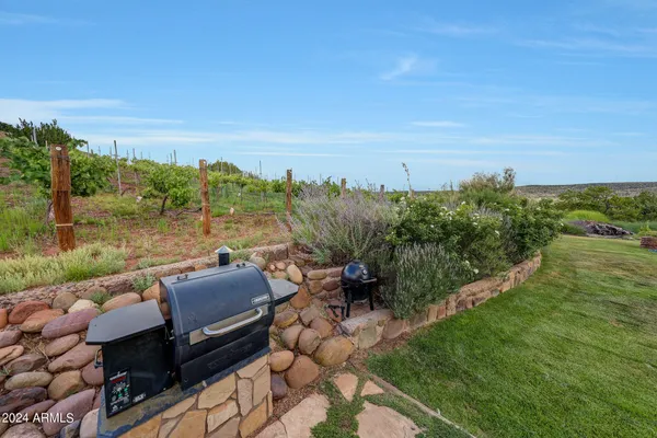 a large kitchen with stainless steel appliances lots of counter space dining table and chair