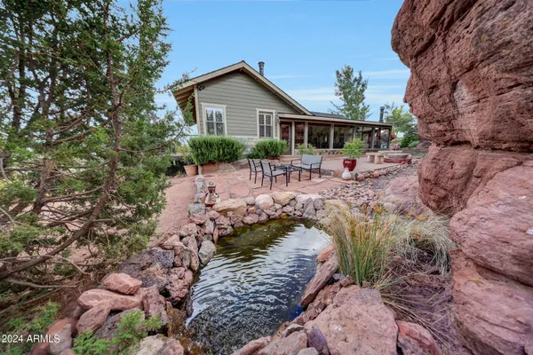 a view of a house with a yard covered with snow in a backyard