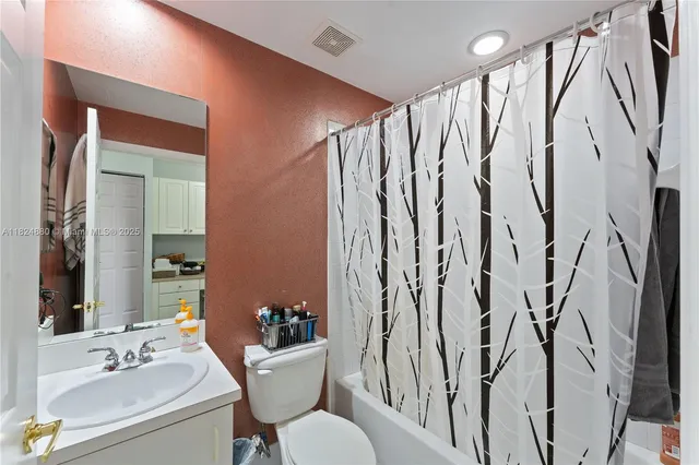 a bathroom with a bathtub sink and mirror