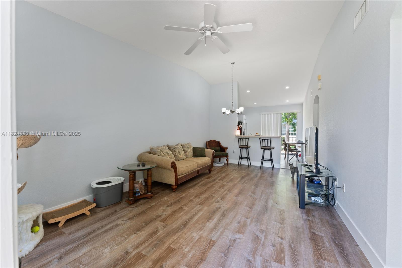 18739 Southwest 28th Street Miramar, FL 33029 - Photo 2 of 15 a living room with furniture and a wooden floor