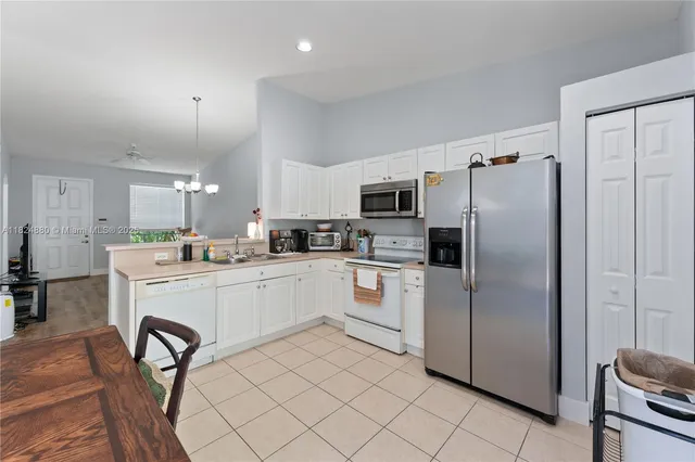a kitchen with stainless steel appliances a refrigerator sink and cabinets