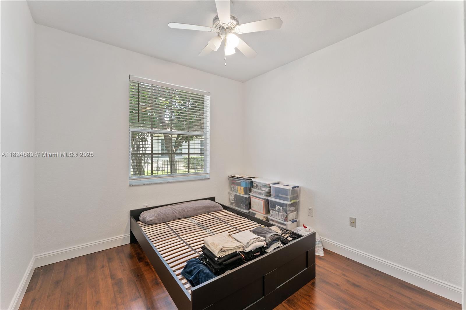 18739 Southwest 28th Street Miramar, FL 33029 - Photo 6 of 15 a bed sitting in a bedroom next to a window