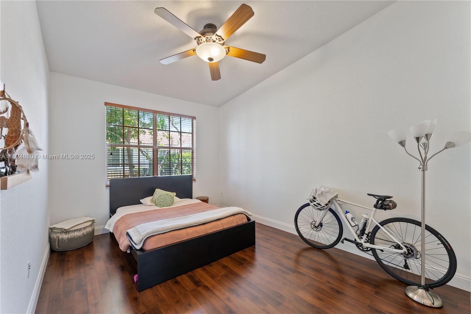 18739 Southwest 28th Street Miramar, FL 33029 - Photo 7 of 15 a bedroom with a bed and a chandelier