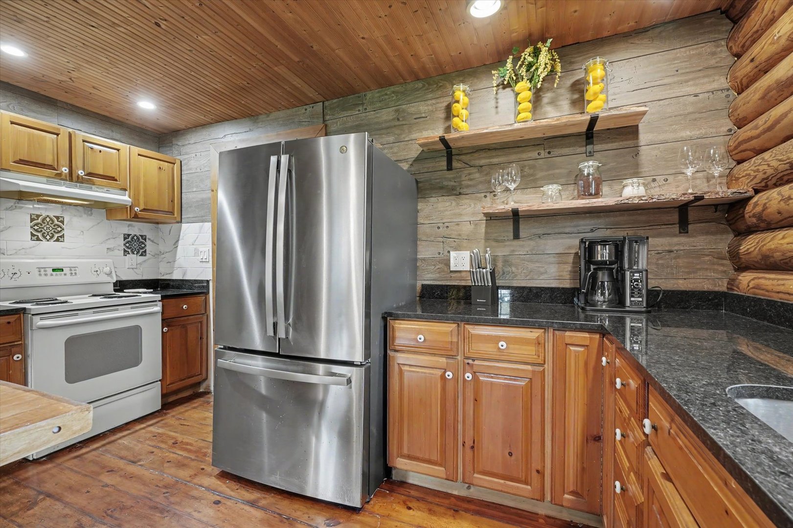 2431 North 1450 East Road Mansfield, IL 61854 - Photo 22 of 78 a kitchen with stainless steel appliances granite countertop a refrigerator a stove and a sink with wooden floor