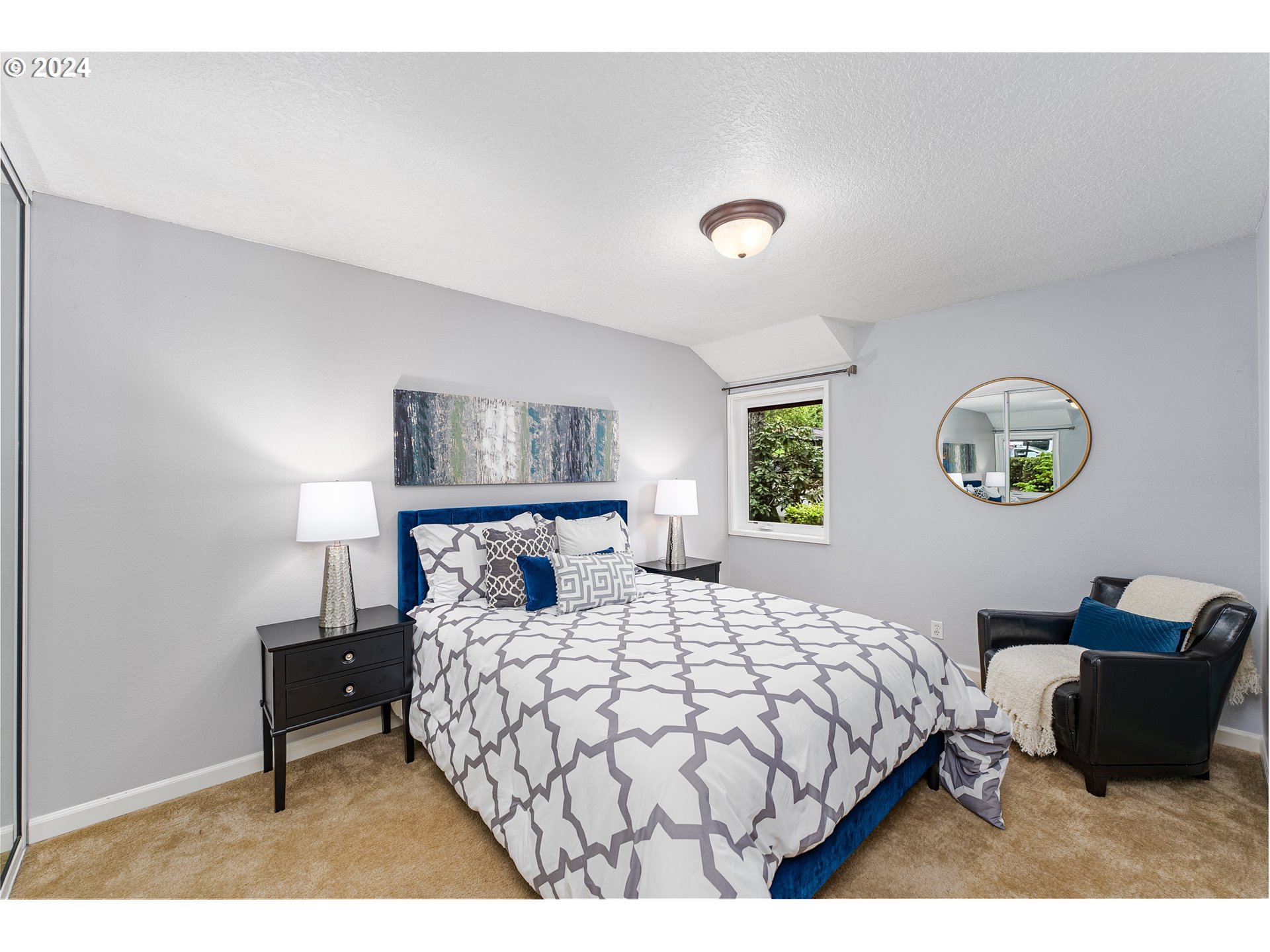 100 Kerr Parkway, Unit 32 Lake Oswego, OR 97035 - Photo 13 of 33 a bedroom with a bed and a lamp on dresser