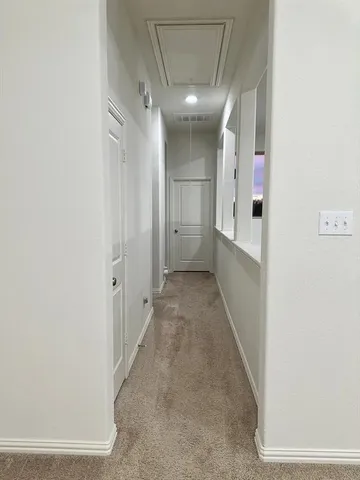 a living room with furniture a flat screen tv and kitchen view