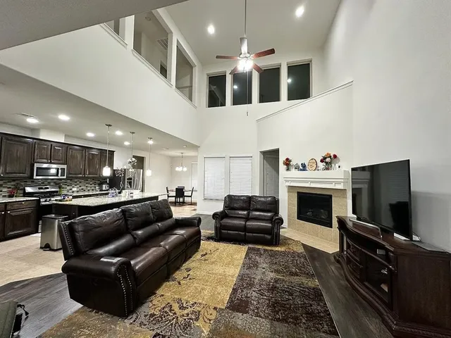 a large bathroom with a granite countertop sink a toilet a mirror and shower