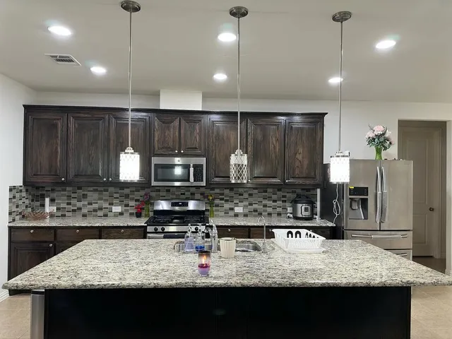 a view of a dining room with a table and chairs