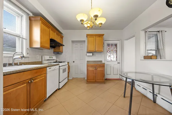 a kitchen with a sink cabinets and window