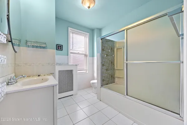 a bathroom with a bathtub a mirror a shower and vanity