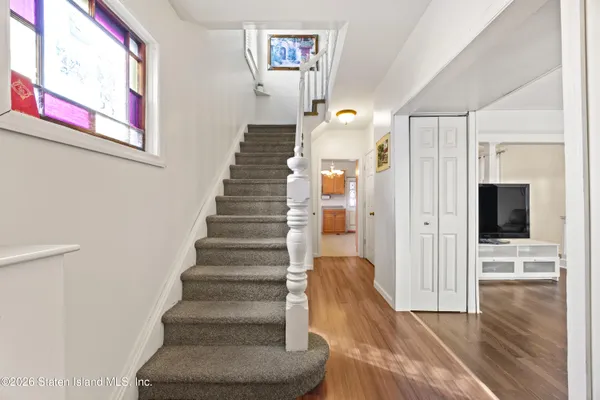 a view of entryway and hall with wooden floor