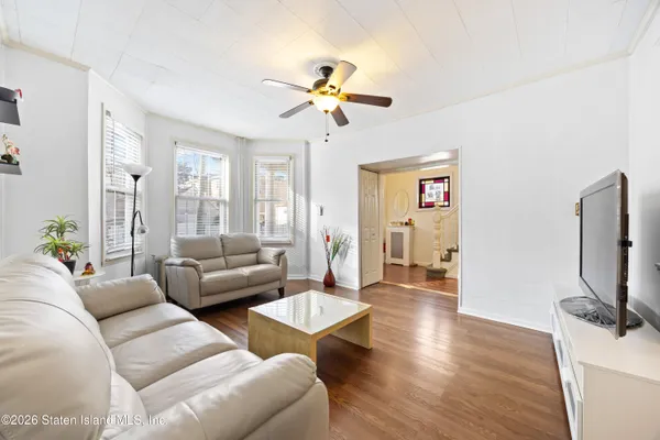 a living room with fireplace furniture and a flat screen tv