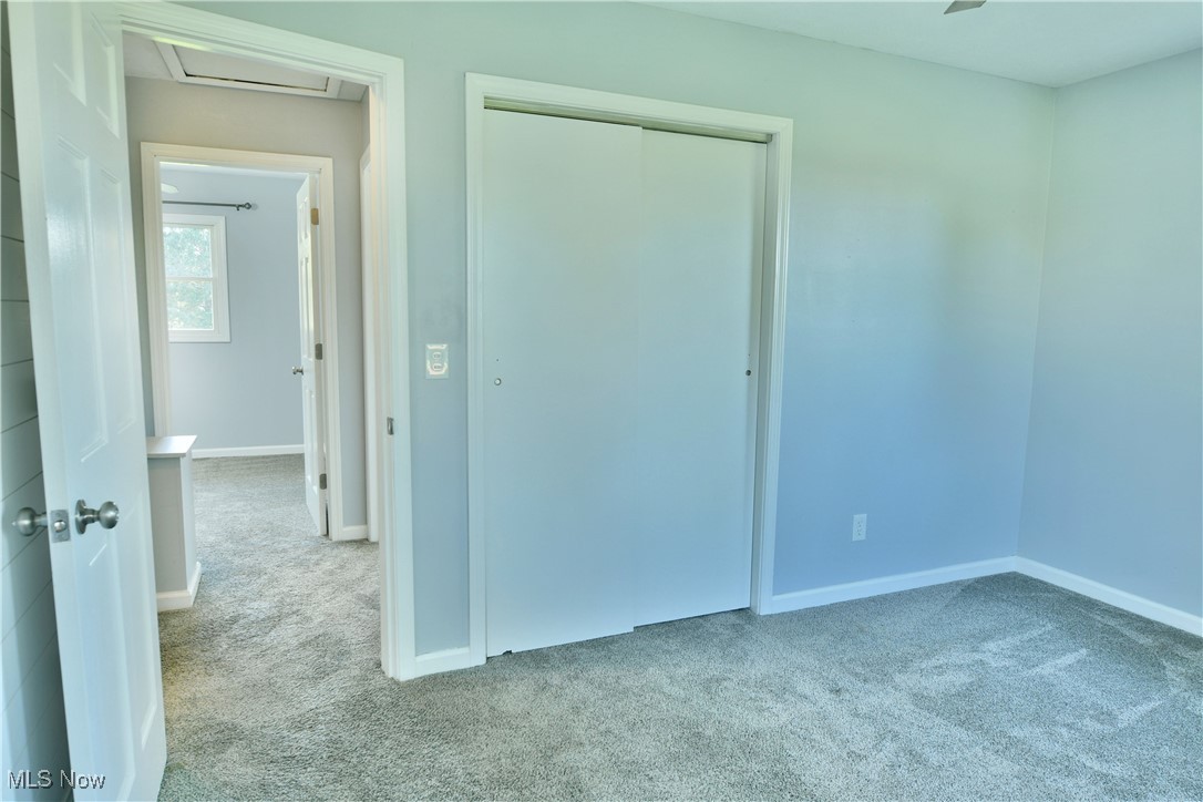 4461 Ridge Road Cortland, OH 44410 - Photo 28 of 47 Unfurnished bedroom with ceiling fan, a closet, and light carpet