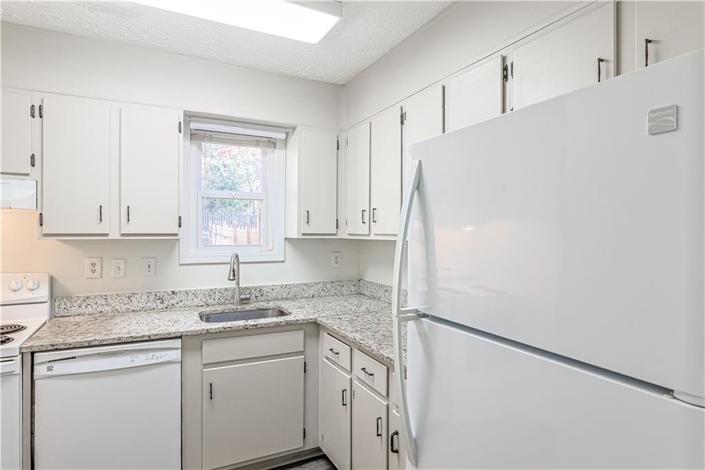 732 South Candler Street Decatur, GA 30030 - Photo 7 of 29 a kitchen with a sink cabinets stainless steel appliances and a window