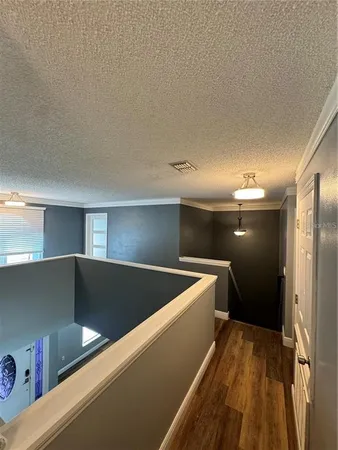 a view of kitchen and a car parked in a hallway