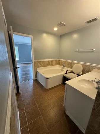 a spacious bathroom with sink and mirror