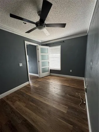 a view of empty room with wooden floor