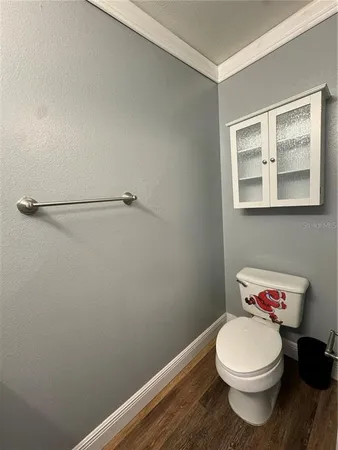 a bathroom with a toilet and a window