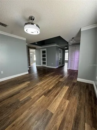 a view of a livingroom with wooden floor