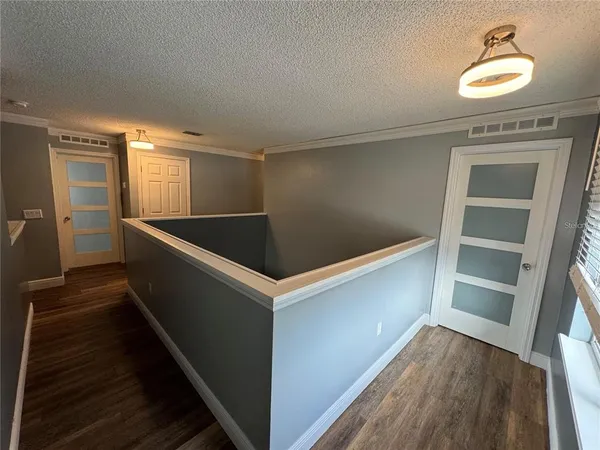 a kitchen with cabinets and wooden floor
