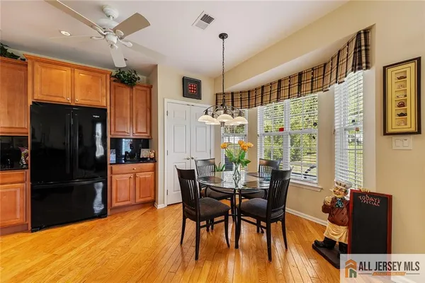 a view of a dining room with furniture and a window