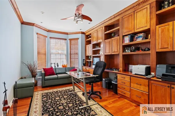 a livingroom with workspace and a couch