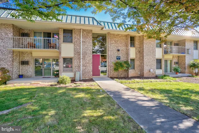 a front view of a house with a yard and table and chairs