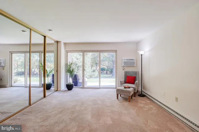 a living room with furniture and large windows