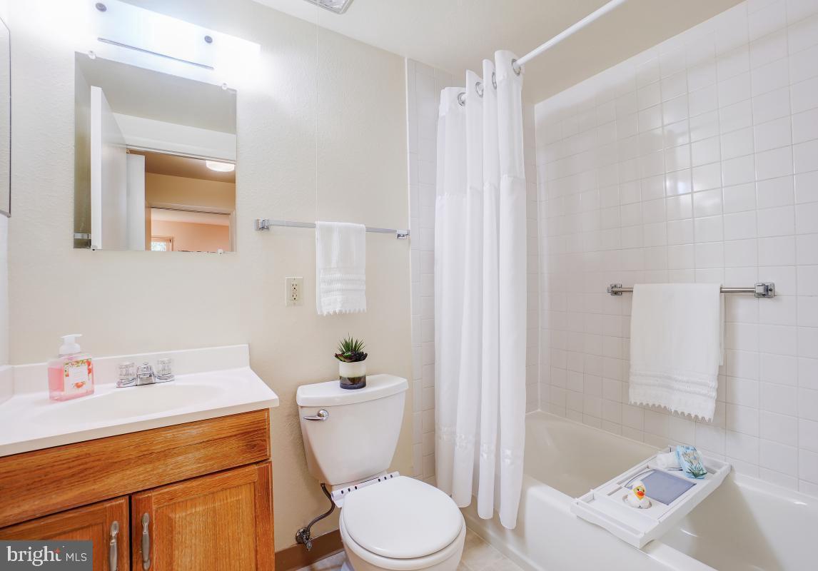 3314 Chiswick Court, Unit 621G Silver Spring, MD 20906 - Photo 5 of 10 a white toilet sitting next to a bathroom sink