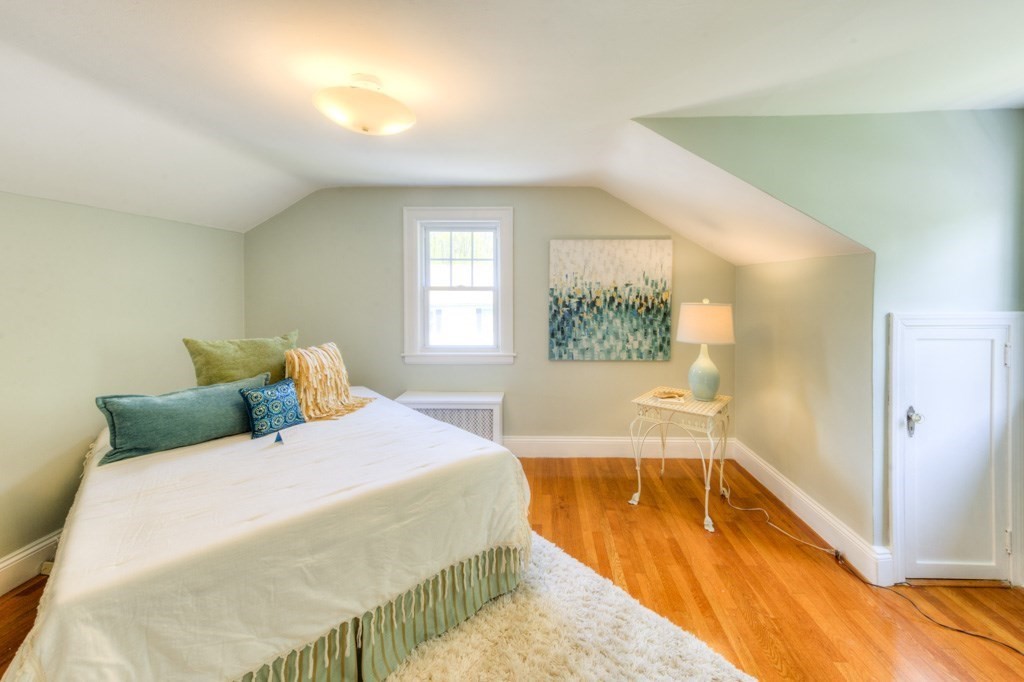 197 Eastern Avenue Worcester, MA 01605 - Photo 28 of 42 a bedroom with a bed and wooden floor