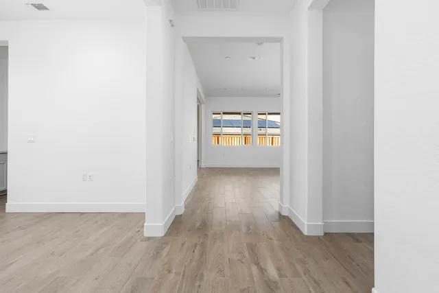 a view of an empty room and wooden floor