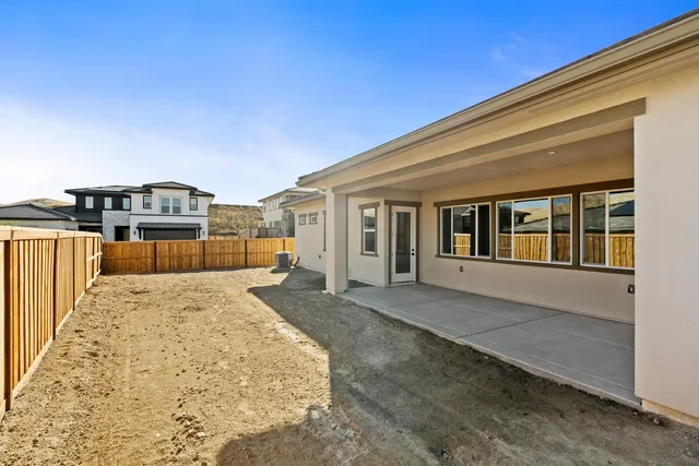 a view of a house with wooden fence