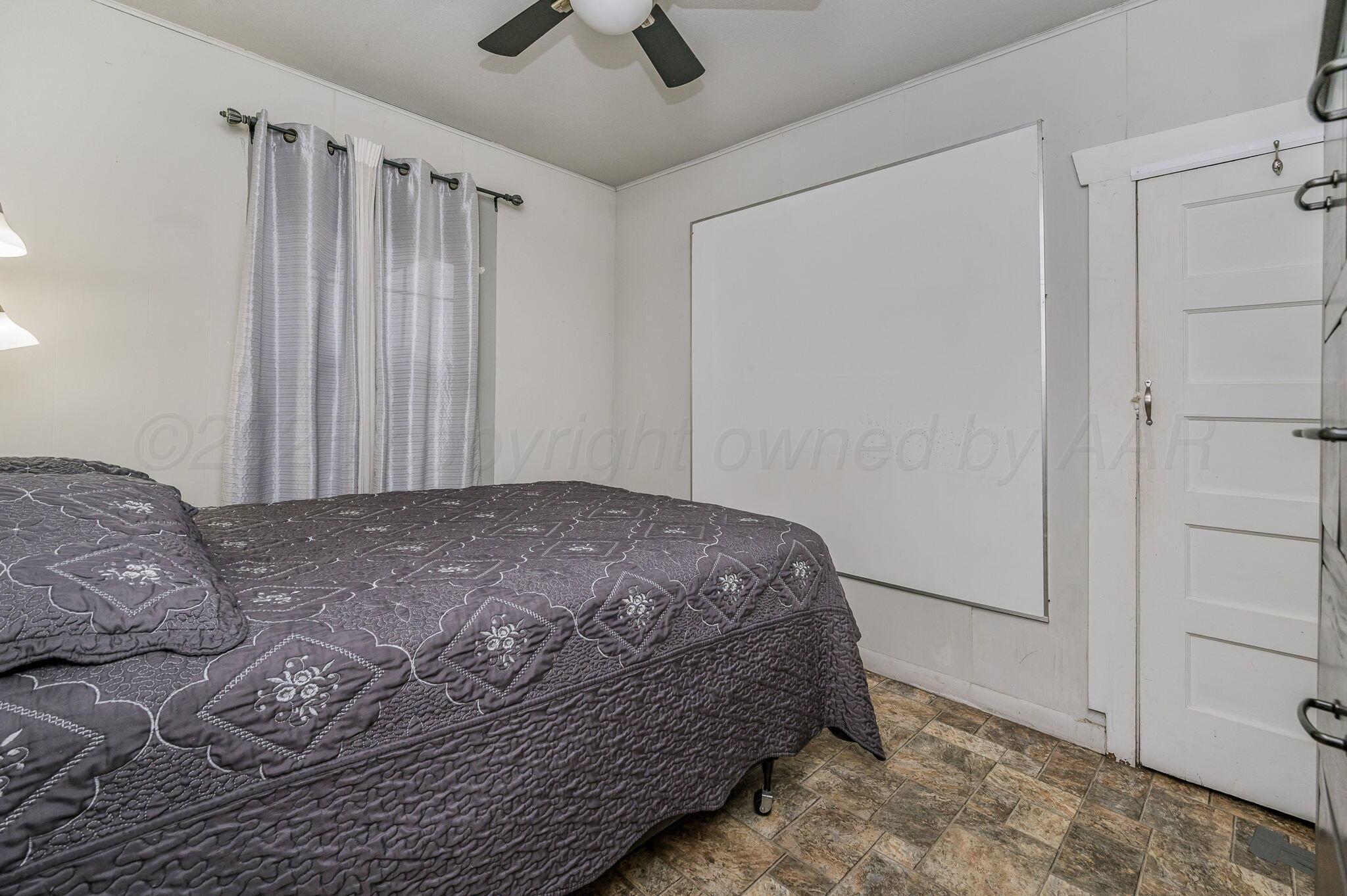 126 South Nelson Street Pampa, TX 79065 - Photo 14 of 16 a bedroom with a bed and a window