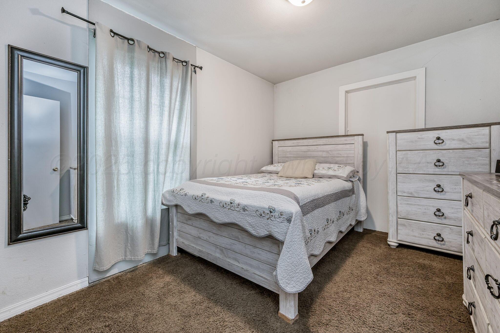 126 South Nelson Street Pampa, TX 79065 - Photo 15 of 16 a bedroom with a bed and a window