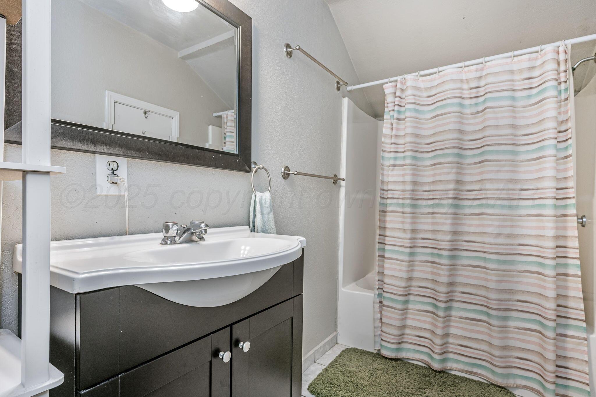 126 South Nelson Street Pampa, TX 79065 - Photo 16 of 16 a bathroom with a sink and a mirror