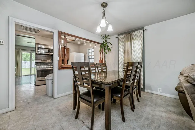 a view of a dining room with furniture and chandelier