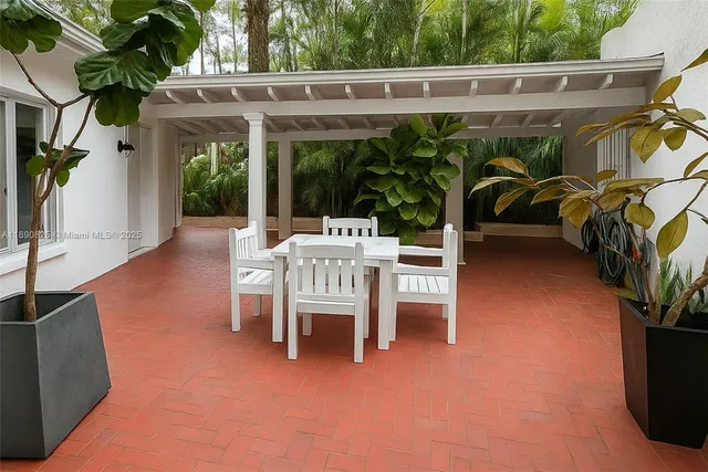 a view of a patio with table and chairs potted plants with wooden floor