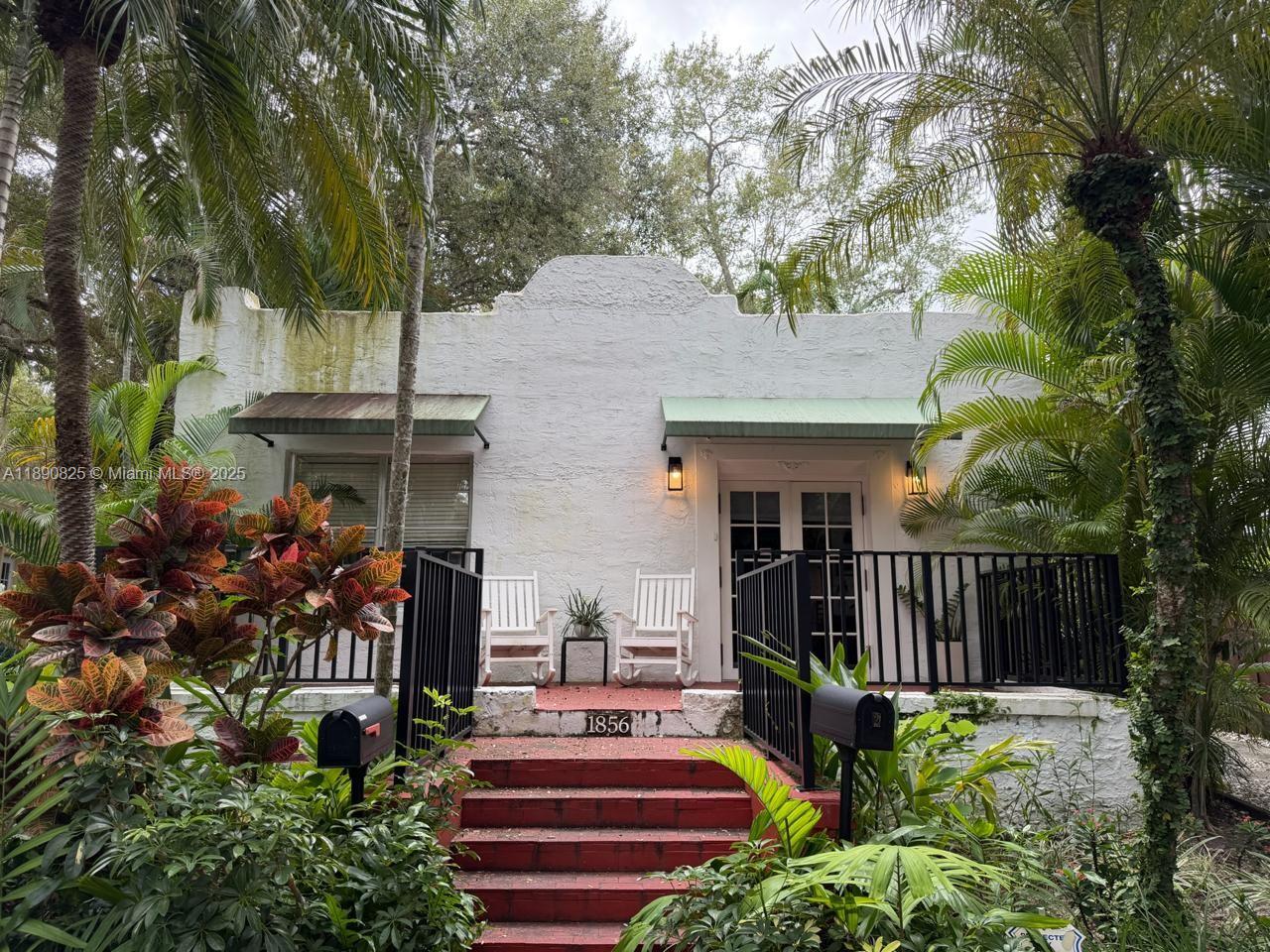 1856 Opechee Drive, Unit 2 Miami, FL 33133 - Photo 13 of 15 a front view of a house with garden