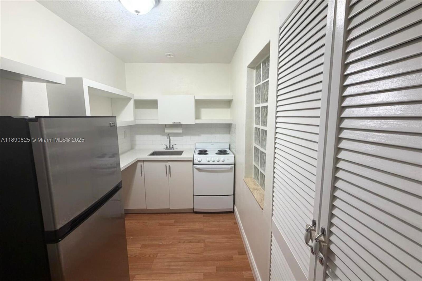 1856 Opechee Drive, Unit 2 Miami, FL 33133 - Photo 3 of 15 a kitchen with a refrigerator and a stove
