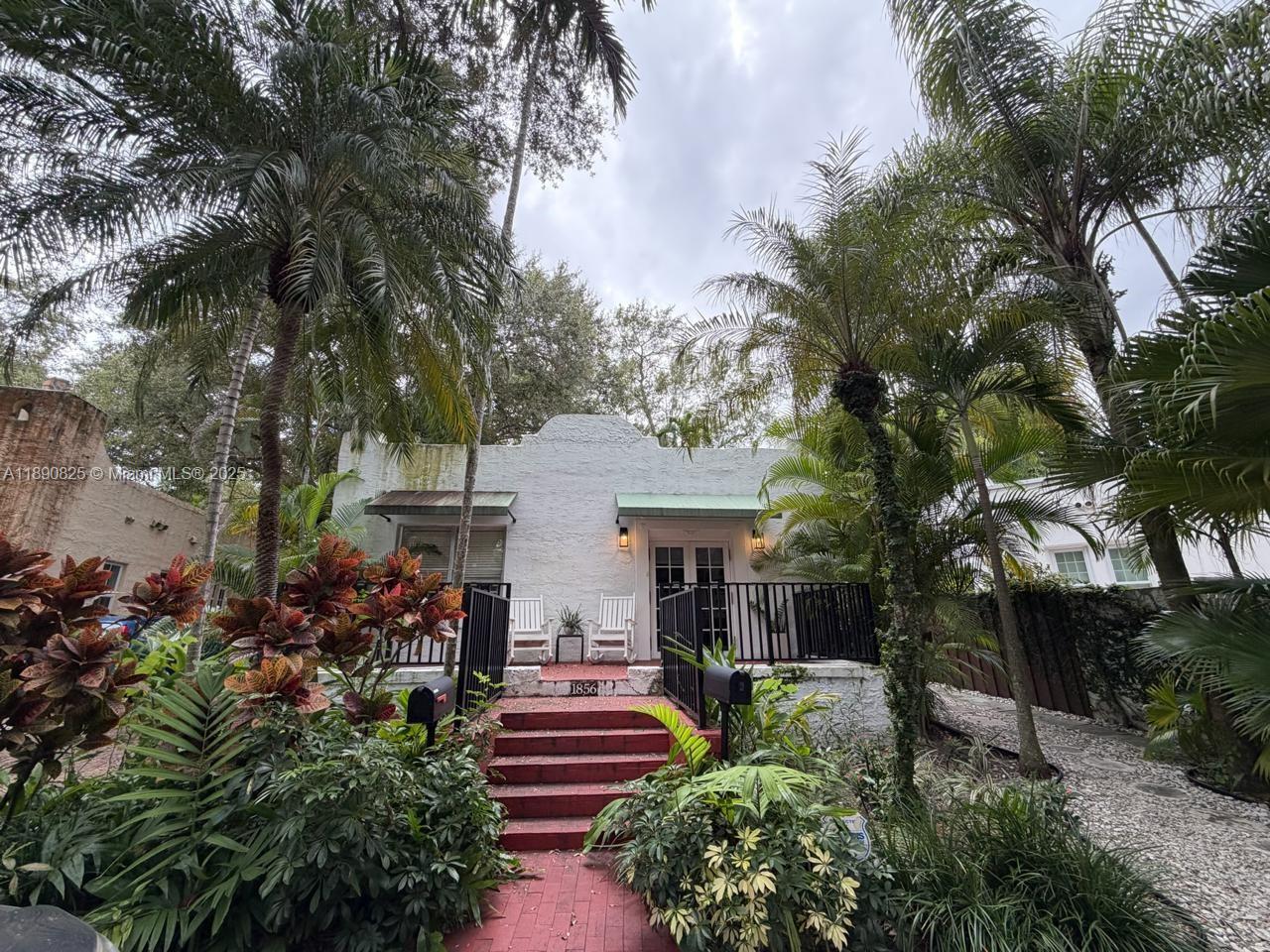 1856 Opechee Drive, Unit 2 Miami, FL 33133 - Photo 6 of 15 a front view of a house with a garden