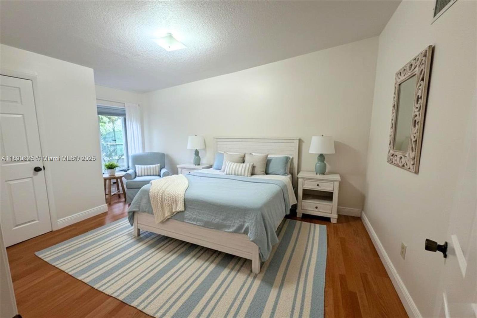 1856 Opechee Drive, Unit 2 Miami, FL 33133 - Photo 9 of 15 a bedroom with a bed and wooden floor