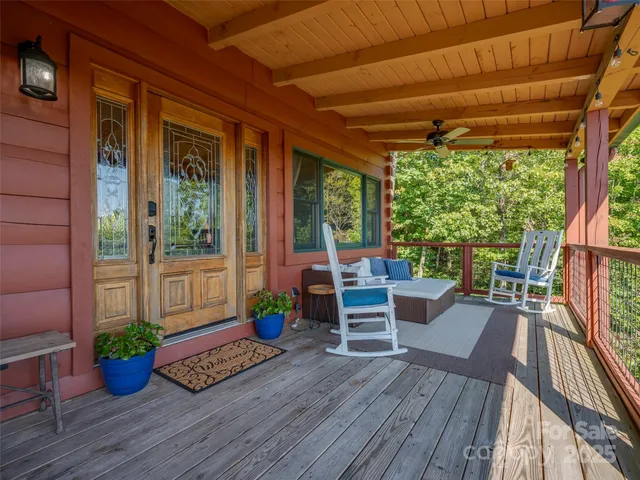 a view of a porch with furniture and wooden floor