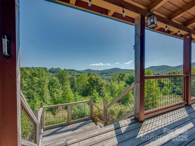 a view of balcony with wooden floor and fence