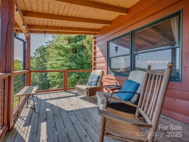 a view of deck with a table and chairs