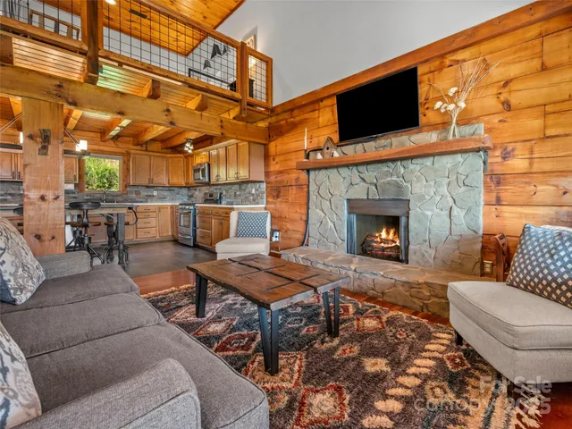 a outdoor space with chairs a fireplace and a flat screen tv