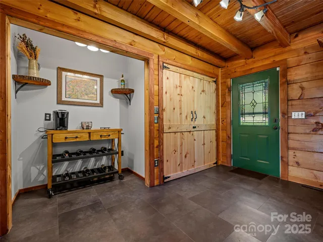 a kitchen with stainless steel appliances a refrigerator a stove a sink and a dining table with wooden floor