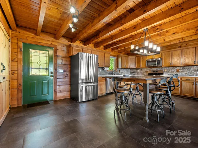 a view of a kitchen with appliances and furniture